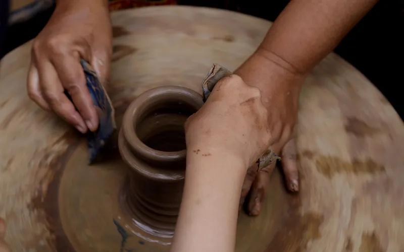 potter shaping clay pot