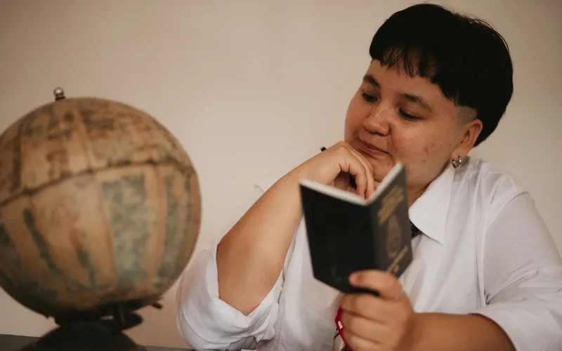 Traveler at a Laos border crossing checkpoint with passport in hand