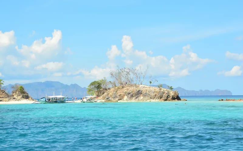 snorkelers boat clear water philippines