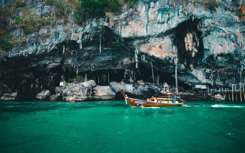 longtail boat limestone cliffs