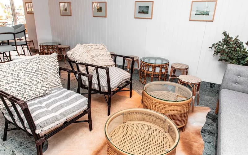 A minimalist boutique hotel room interior in northern Vietnam, natural rattan furniture, sheer white curtains diffusing after